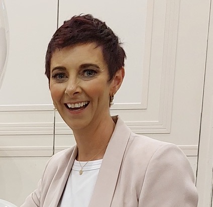 Deirdre Treanor smiling in a blush blazer
