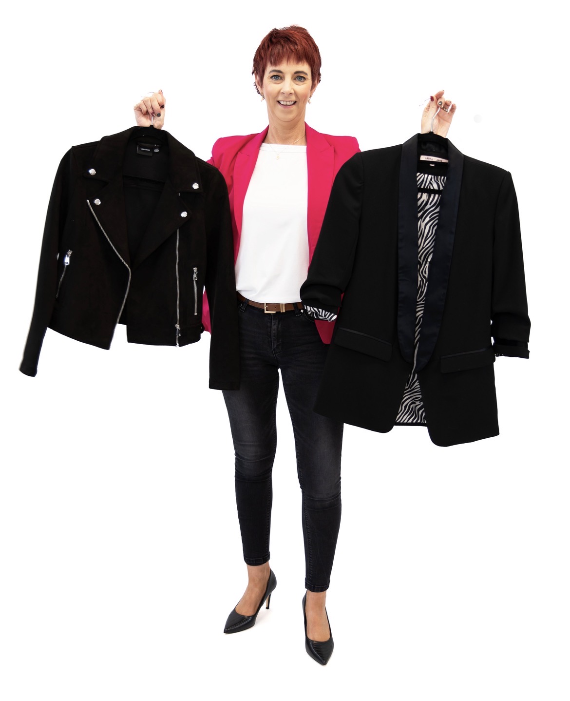 Deirdre Treanor in a cerise blazer holding two jackets on hangers