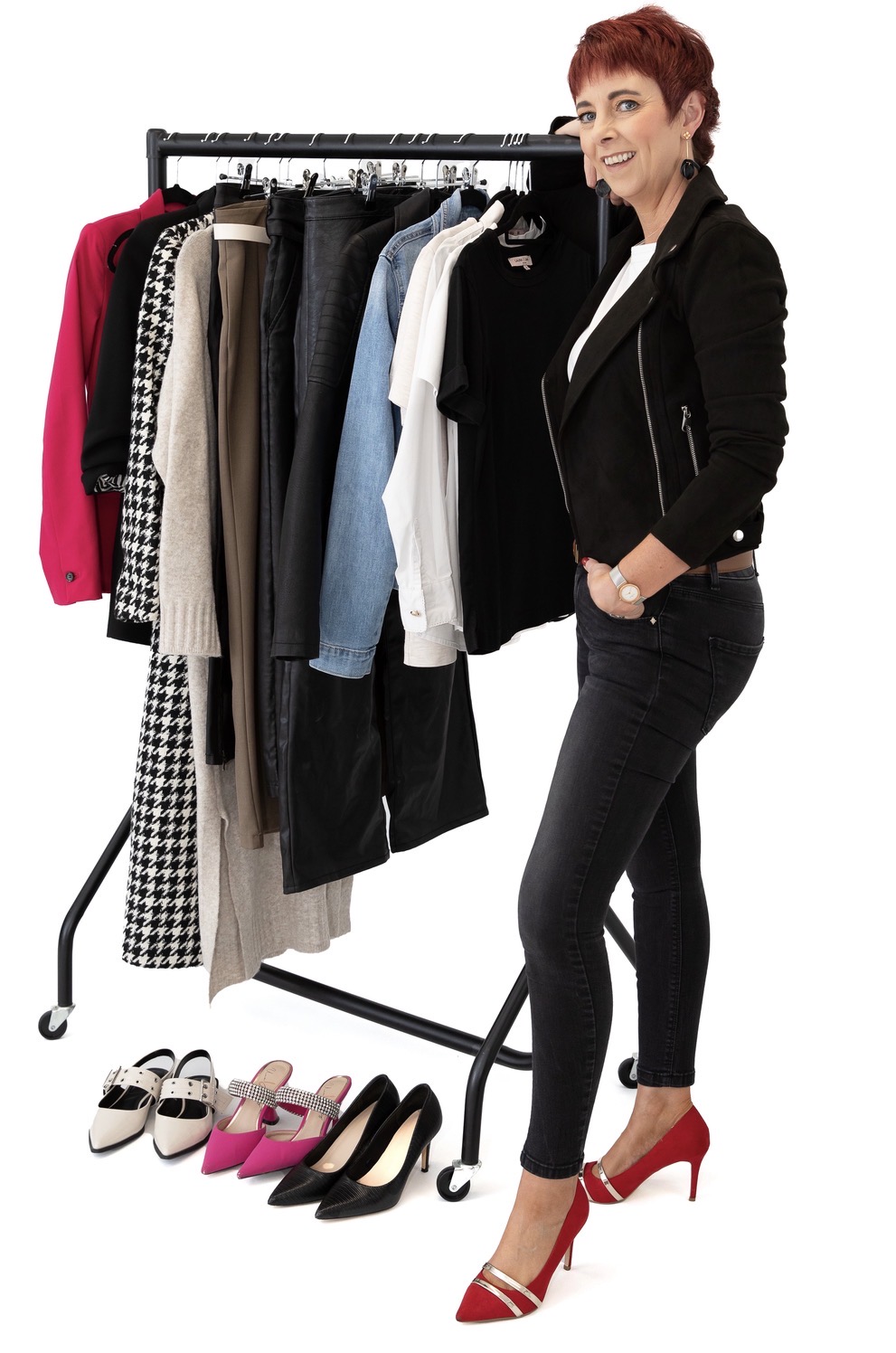 Deirdre Treanor beside a curated clothing rail with styled shoes
